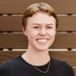 Woman with short, hair smiles at the camera