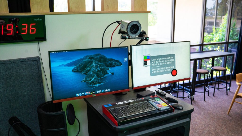 a set of computer monitors and video cameras