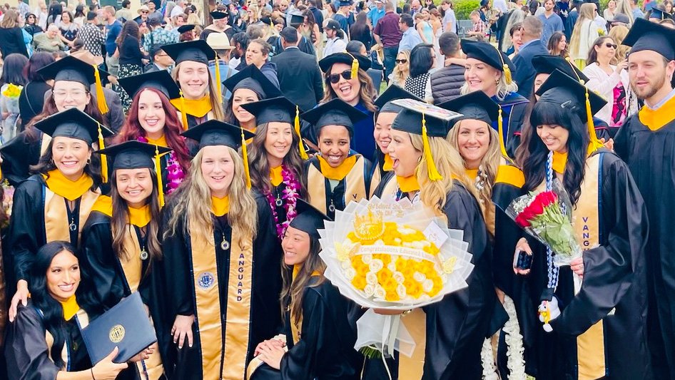 Students gather in graduation regalia