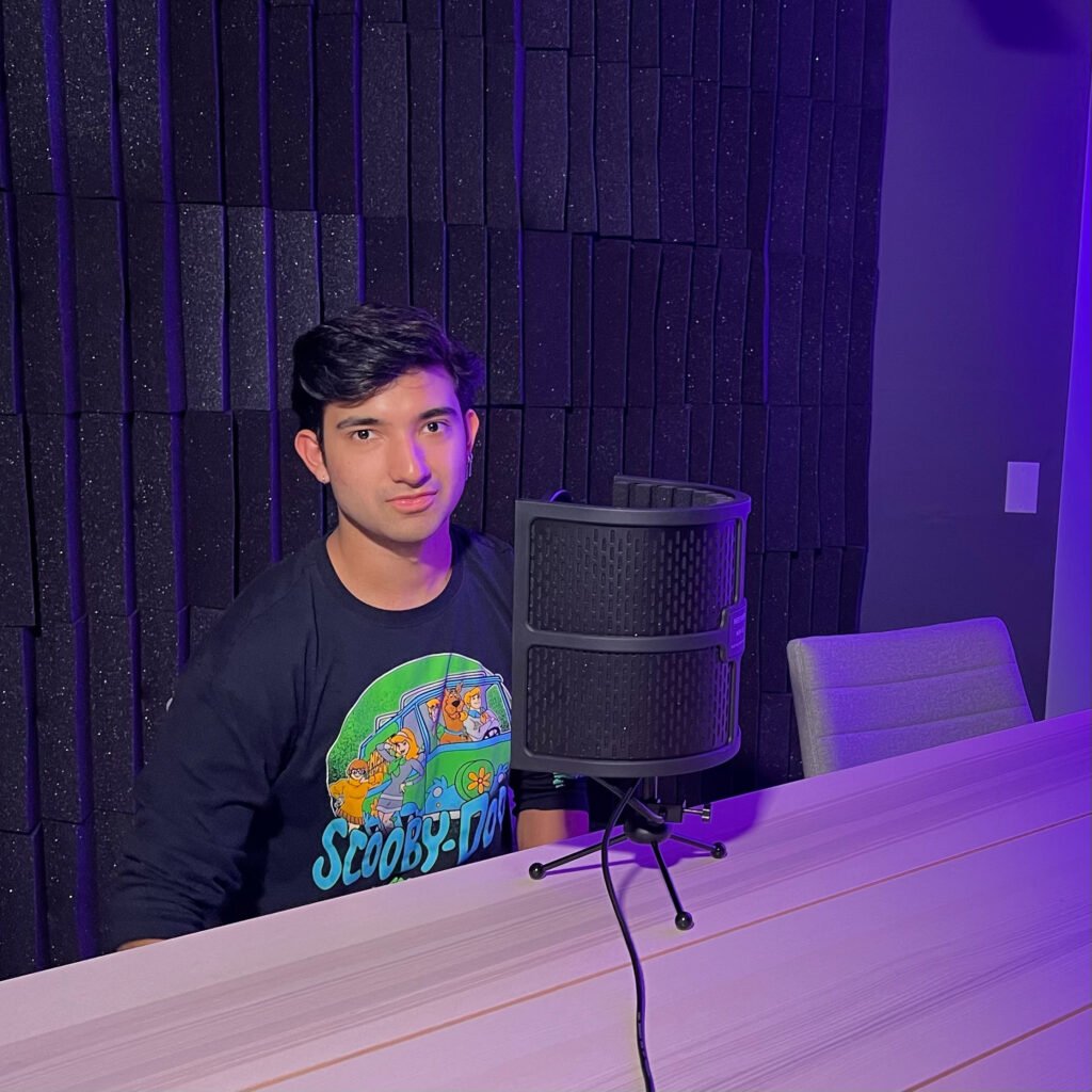 A young man with a podcast microphone