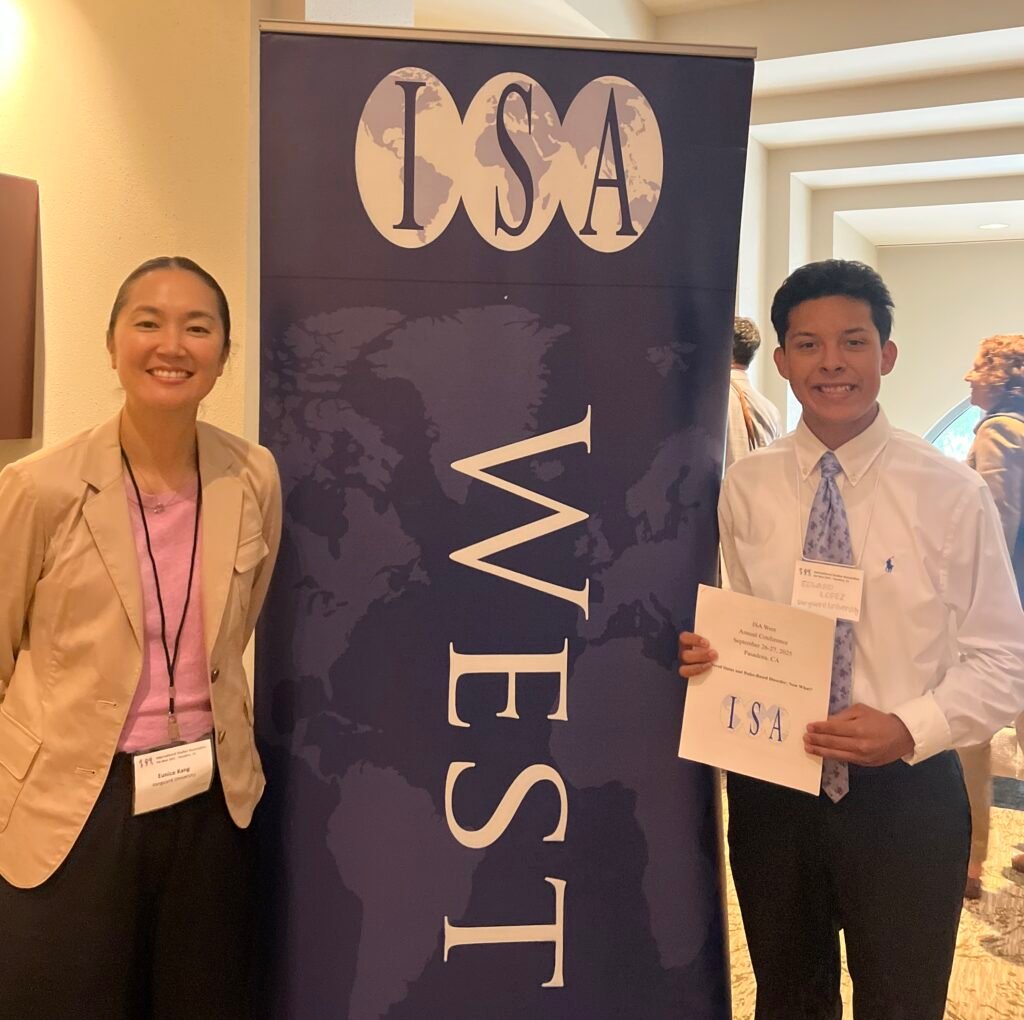 Vanguard HPS student, Edward Lopez, and Dr. Eunice Kang in front of ISA-West signage