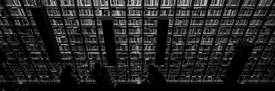 Large bookshelf with people looking up at it